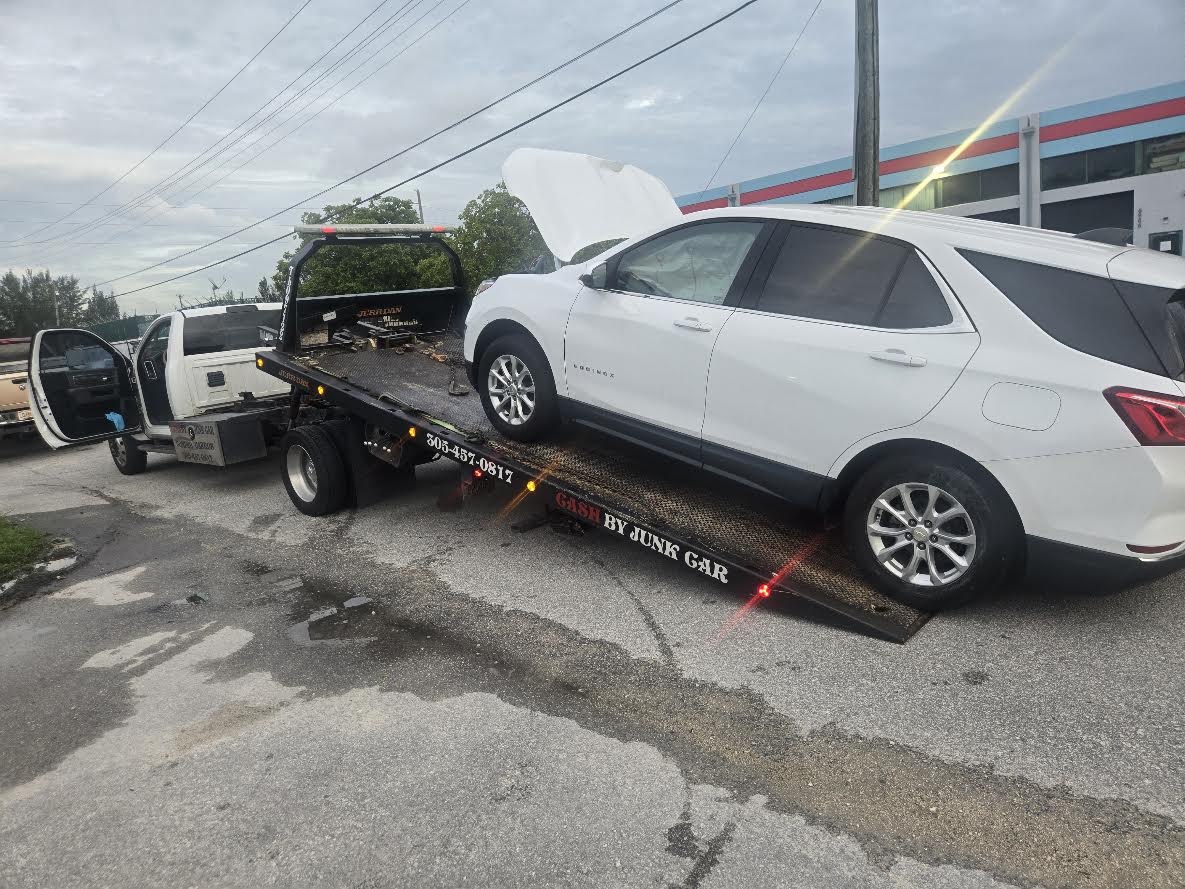 White Chevrolet SUV being loaded onto our flatbed truck for vehicle collection